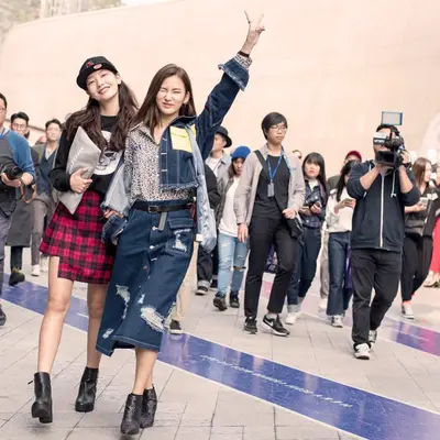 A group of stylish women walking down the streets of Seoul, showcasing the eclectic and vibrant street style that defines Korean women's fashion