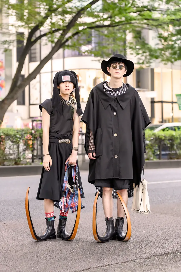 A group of stylish individuals posing on a Seoul street, showcasing the eclectic and edgy aesthetic of Korean streetwear fashion