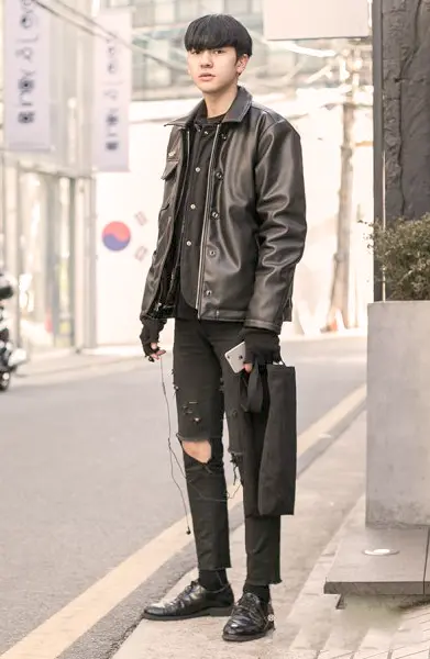 A K-pop idol posing in a chic and trendy outfit, exemplifying the influence of K-pop fashion on global style trends and the synergy between music and fashion in Korean culture