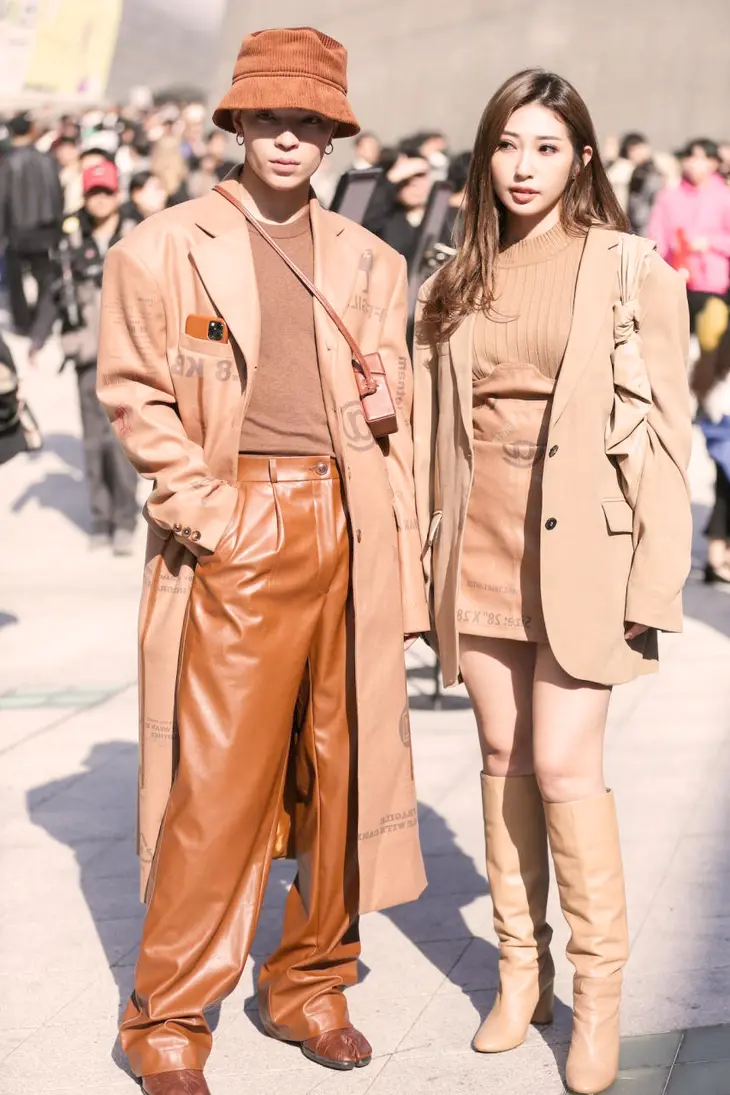 A group of stylish individuals walking down the streets of Seoul, showcasing the eclectic and vibrant street style that defines K-Fashion