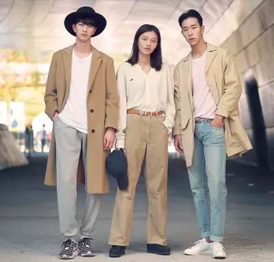 A group of models wearing diverse and gender-neutral outfits on a Seoul runway, representing the evolution of gender fluid fashion within Korean culture